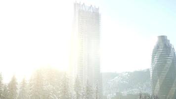 sity and forest in snow at sunrise photo