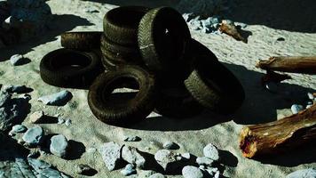 old abandoned tyres on sea shore photo