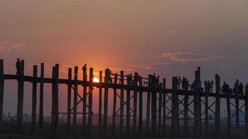 sunset and silhouette at U Bein Bridge, Myanmar, Burma photo