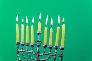 Hanukkah menorah with candles green background isolation photo