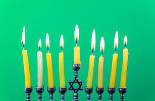 Hanukkah menorah with candles green background isolation photo