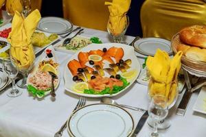 Beautifully decorated catering banquet table with different food snacks and appetizers photo