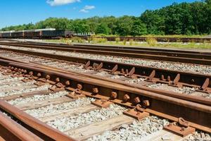 railway goes to horizon in green landscape photo