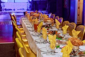 Beautifully decorated catering banquet table with different food snacks and appetizers photo