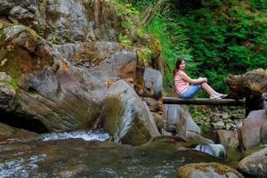 Woman sitting at the wood bridge photo