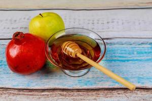 Pomegranate, apple and honey, traditional food of jewish New Year celebration, Rosh Hashana. photo