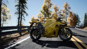 sportbike on tre road in forest with sun beams video