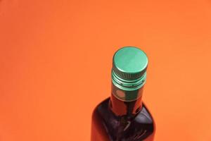 Olive oil container over orange background photo