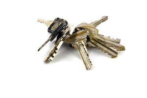 Large bunch of keys isolate on white background photo