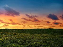 Dramatic glowing sunset over the grassland photo