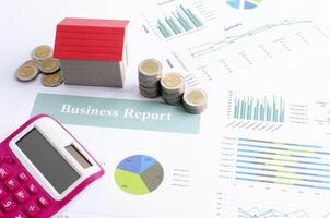 Money coin stack and red house and pink calculator for business finance concept photo