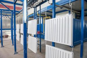 workshop for assembling and painting household heating radiators. conveyor line painting and drying of household heating radiators photo