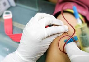 Phlebotomist collected blood in hospital for biochemical analysis photo