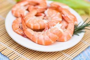 fresh shrimps served on white plate with rosemary, boiled peeled shrimp prawns cooked in the seafood restaurant photo