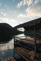 Bamboo raft pier by the river in the evening photo