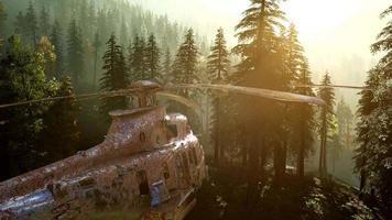 old rusted military helicopter in the mountain forest at sunrise video