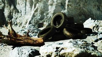 Old tire on the seashore and pollution of nature video