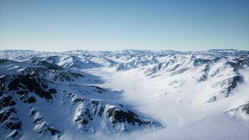 8K Aerial Landscape of snowy mountains and icy shores in Antarctica video