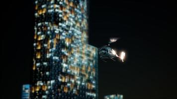 slow motion helicopter near skyscrapers at night video