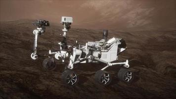 Curiosity Mars Rover exploring the surface of red planet. Elements of this image furnished by NASA video