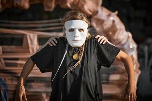 Two girls acting in white theater mask, outdoor art theatrical performance, art festival photo