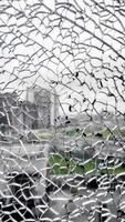 Broken glass window. closeup view from broken window. shattered window glass. city view from broken window. photo