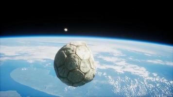old soccer ball in space on Earth orbit video