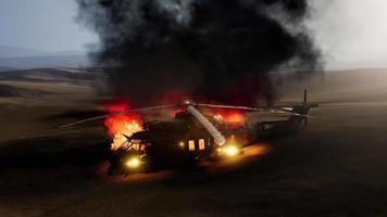 burned military helicopter in the desert at sunset video