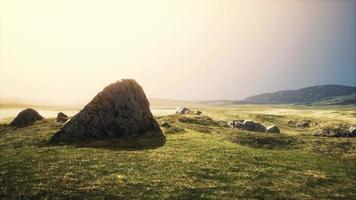 big sand stone and green grass hill background video