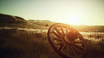 Old wooden wheel on the hill at sunset video