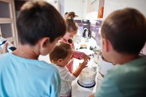 Kids cooking at kitchen, happy children's moments. photo