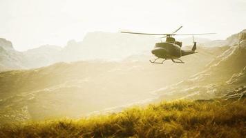 slow motion Vietnam War era helicopter in mountains video