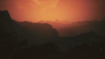 dramatic sky over rocky mountains at sunset video