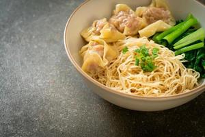 dried egg noodles with pork wonton or pork dumplings without soup photo