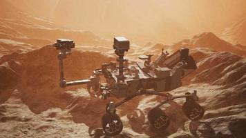 Curiosity Mars Rover exploring the surface of red planet. Elements of this image furnished by NASA video