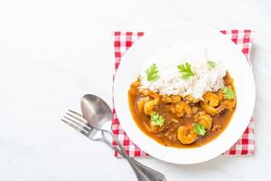 Shrimps in curry sauce on rice photo