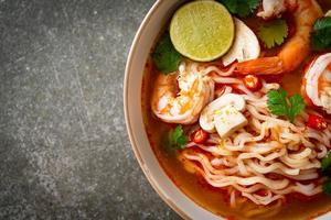 instant noodles ramen in spicy soup with shrimps or Tom Yum Kung photo