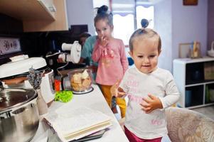 Kids cooking at kitchen, happy children's moments. photo