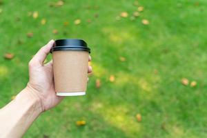 hand holding hot coffee glass photo