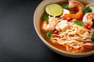 instant noodles ramen in spicy soup with shrimps or Tom Yum Kung photo