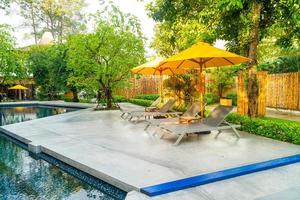 umbrella and pool bed around swimming pool photo