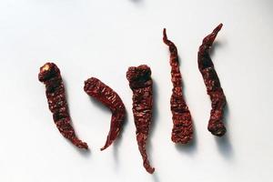 Byadgi Red Dry Chili or Bedgi Mirch, Lal Mirchi on white background. It is a famous variety of chili mainly grown in the Indian state of Karnataka. photo