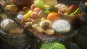 food table with wine barrels and some fruits, vegetables and bread