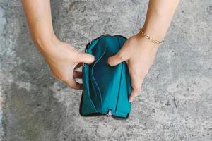 Woman hands holding an empty wallet. bankrupt concept image photo