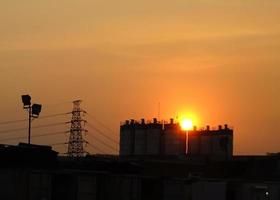 Silhouette of fly over construction site, sunset background photo