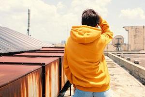 Back view of woman wearing yellow hoodie jacket photo