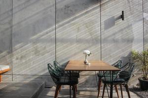 Interior design dining room with industrial background concrete wall and pot plant photo