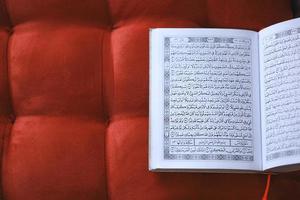 Top view The holy Quran on red  background photo