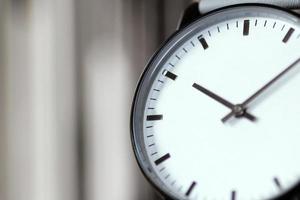 White wristwatch, close up detail. Blurred background photo