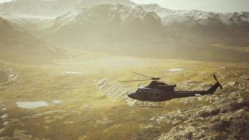 slow motion Vietnam War era helicopter in mountains video